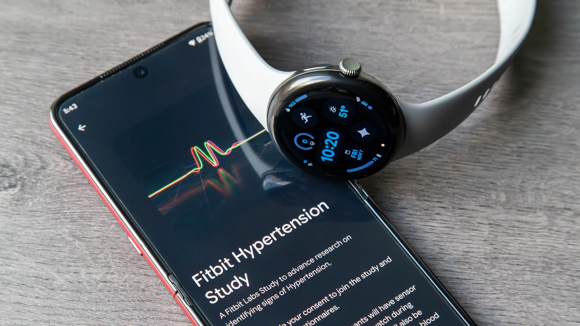 A photo of the Google Pixel Watch 3 sitting atop an Android phone showing a fitbit hypertension study from labs.